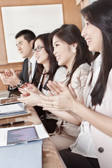 Business people clapping their hands