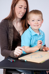 Mother and son drawing and coloring together