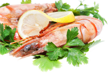 two appetizing tiger shrimps with lemon slice and parsley