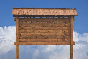 Fototapeta premium Wooden sign on a blue sky