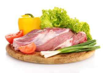 Raw meat and vegetables on a wooden board isolated on whitе