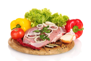Raw meat and vegetables on a wooden board isolated on whitе