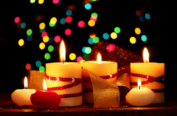 Beautiful candles on wooden table on bright background