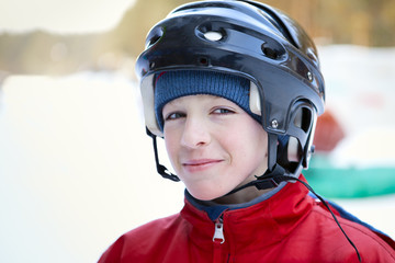 Fototapeta na wymiar Portrait of teenager wearing helmet, winter