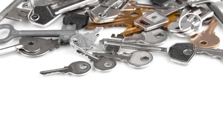 Lot of metal keys isolated on white