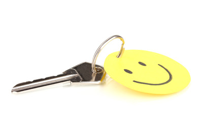 Key with smile-charm isolated on white