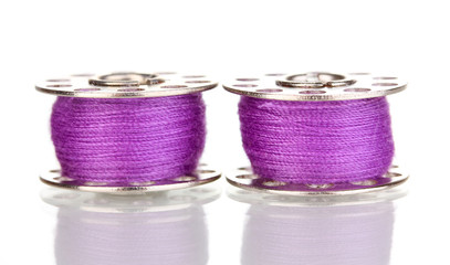 Metal spools of thread isolated on white