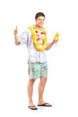 Full length portrait of a young man holding a cocktail and givin