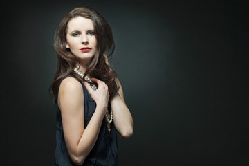 Fashion female model with long curly hair.