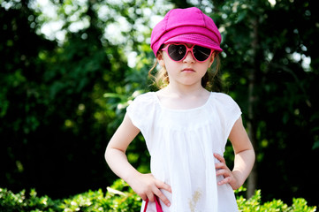 Beauty little girl in white dress posing ourdoors