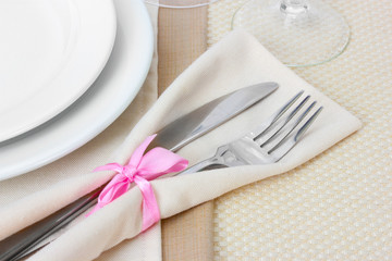 Table setting with fork, knife, plates, and napkin