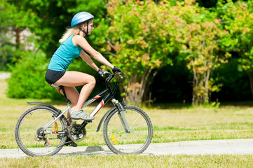 Young smiling woman on bike