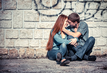 Teenagers Sitting by a street