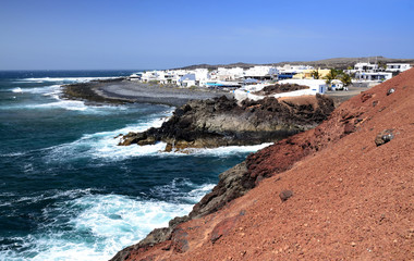 Lanzarote's village on the coast with volcano ground details