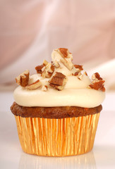 Delicious carrot cake cupcake with cream cheese frosting and nut