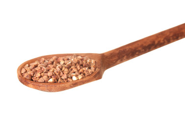 Wooden spoon with raw buckwheat isolated on white