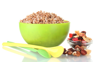 Boiled buckwheat in a green bowl isolated on white