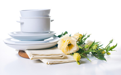 plates and a bouquet of yellow flowers