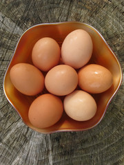 Organic free range eggs outdoors in a carnival glass bowl.
