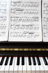 detail of piano keyboard and sheet music