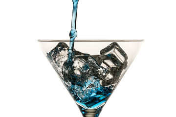 Blue drink with lots of ice cubes on white background