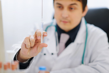 Closeup on syringe in hand of medical doctor