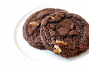 Two Chocolate Chip Cookies on a white plate