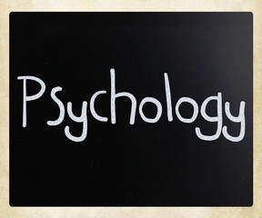 The word 'Psychology' handwritten with white chalk on a blackboa
