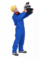 craftsman holding a cutting machine