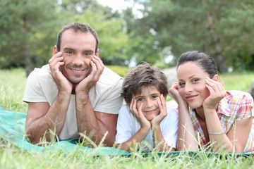 Fototapeta premium happy family lying on the grass