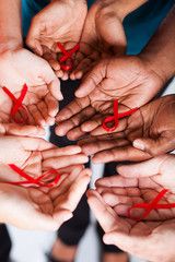 multiracial people holding red ribbon for AIDS HIV awareness - obrazy, fototapety, plakaty