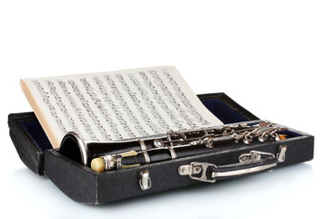 Antique clarinet in case and notebook with notes isolated