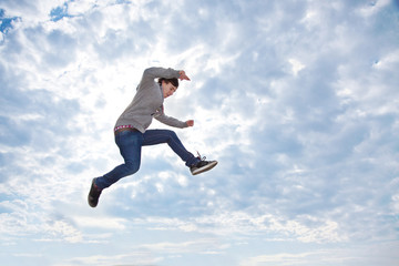 Fototapeta Young man jumping for joy in the air obraz