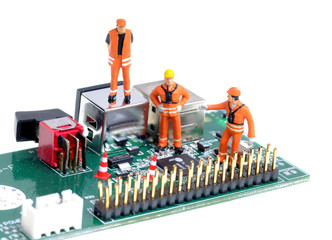 tiny construction engineers figures examine integrated circuit