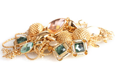 Various gold jewellery isolated on white