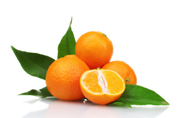 Ripe tasty tangerines with leaves and segments isolated on white