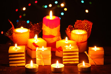 Wonderful candles on wooden table on bright background