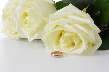 White roses and wedding ring