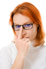 A beautiful girl with red hair wearing glasses thinking