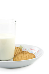 Crumbly cookies on dish with glass of milk