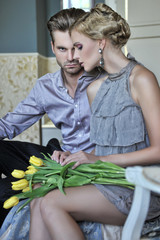 Handsome couple in fashionable room - obrazy, fototapety, plakaty