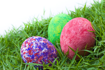 colorful painted three easter eggs on the grass