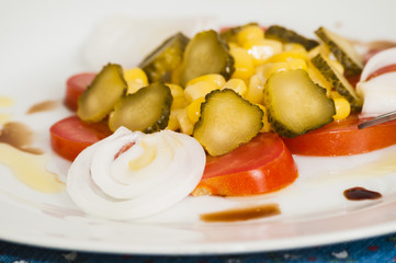 salad of tomatoes, onions, cucumbers and corn