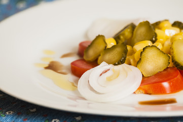salad of tomatoes, onions, cucumbers and corn
