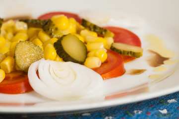 salad of tomatoes, onions, cucumbers and corn