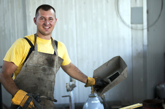 Smiling Young Happy Satisfied Welder At Work