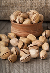 Cracked and Dried Pistachio Nuts In A Wooden Bowl