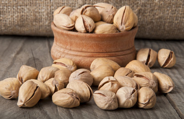 Cracked and Dried Pistachio Nuts In A Wooden Bowl