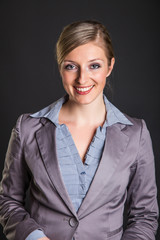 Woman in formal dress on dark gray background