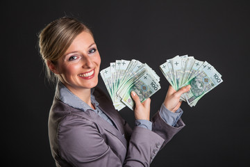 Woman with polish zloty money on dark gray background - obrazy, fototapety, plakaty